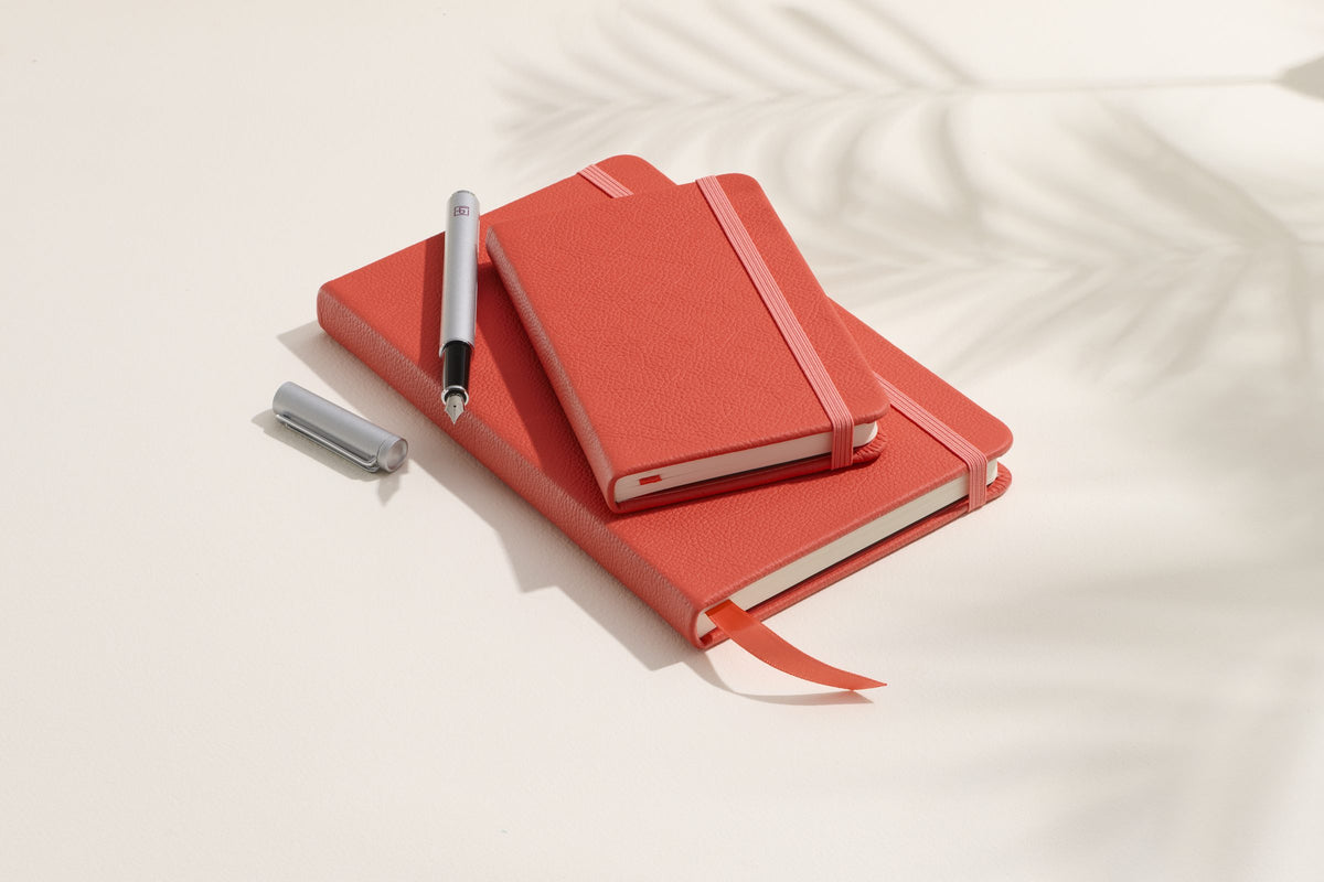 Coral Red Inspire notebooks, pocket and large, with a pen