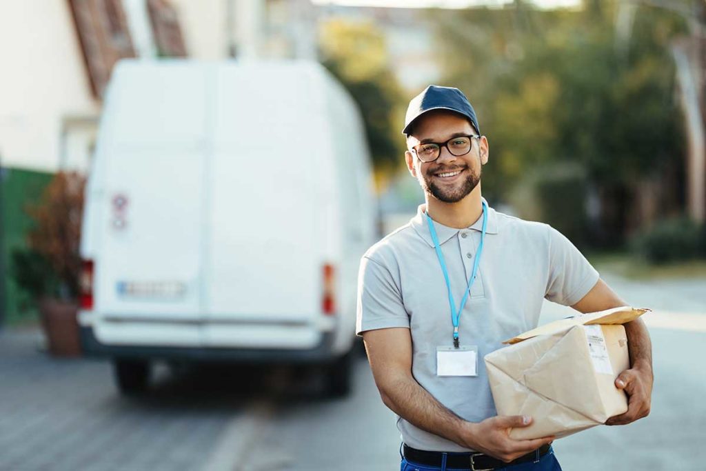 Smiling delivery man making sure customers are satisfied with product and delivery