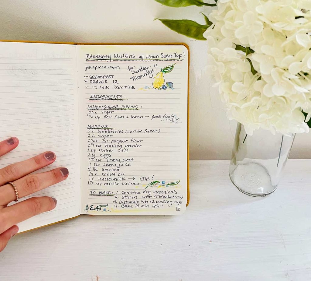 Handwritten recipe in a journal with hydrangea