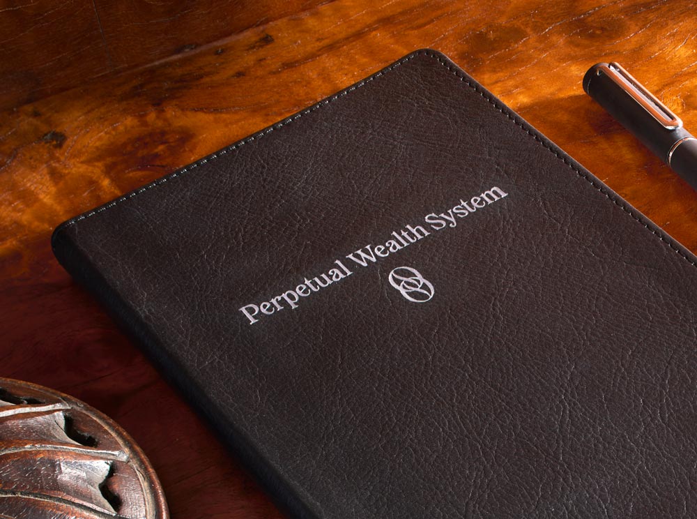Tuxedo Black journal with logo that reads Perpetual Wealth Systems foiled stamped on cover